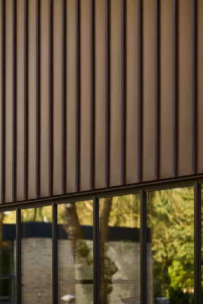 New sports hall in the “forest” wrapped in acorn-brown steel profiles, Risskov Efterskole, Tretommervej 31A, 8240 Risskov, Denmark